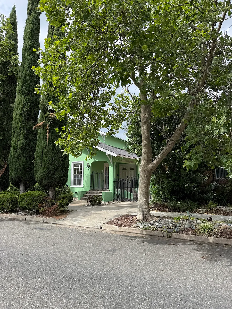 Photo 1 of 14 - 3235 T St - Sacramento, CA Front of home with large trees for shade and privacy. - 3235 T St