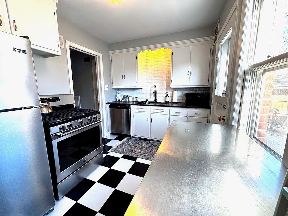 Modern kitchen with stainless appliances including a gas stove and dishwasher