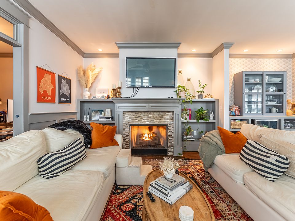 Living room with gas fireplace and private office off living room, with window to back patio