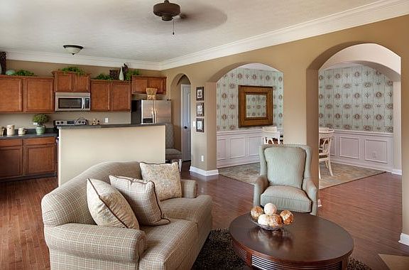 The open floor plan of this modern ranch home keeps you connected. Optional hardwood flooring unites