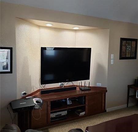 Spacious living room with vaulted ceiling, gas fireplace & large windows let in tons of light.