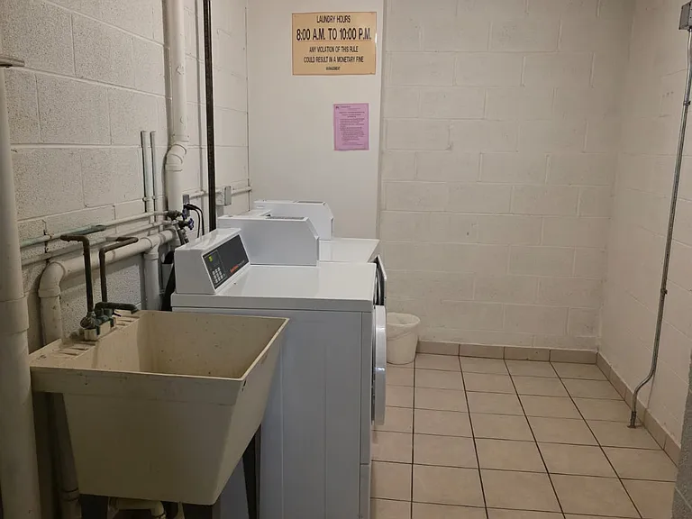 Laundry across the kitchen in the hallway.