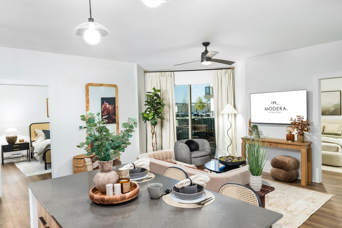 An open-concept living space at Modera Nations in Nashville highlights wide-plank flooring, natural light, and seamless flow designed for everyday living.