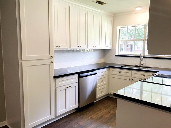 Brand new kitchen with granite countertops and subway tile backsplash.