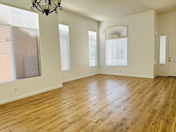 Bright formal living and dining area just off the front entry, featuring abundant natural light and wood-look flooring.