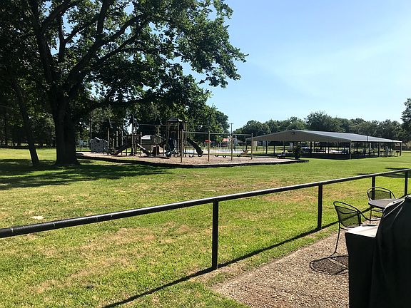 The city park with a playground, covered picnic tables and a splash pad borders the community.