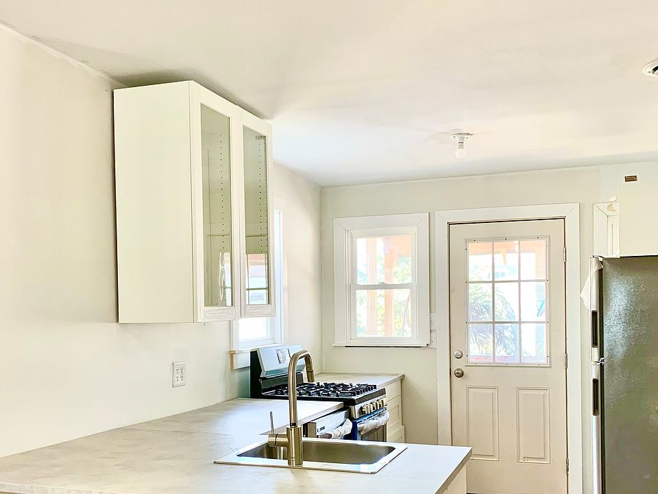 Kitchen towards with backdoor to patio/private garden.