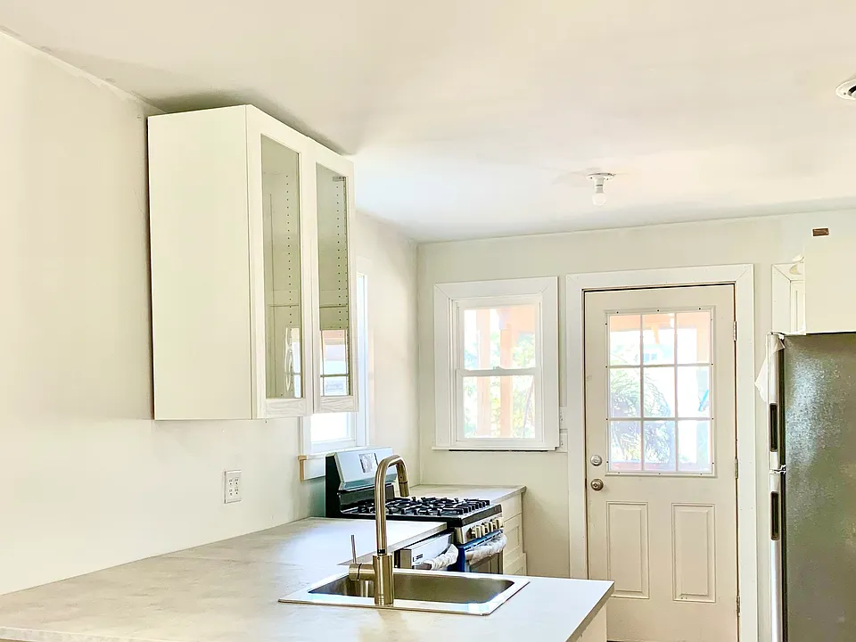Kitchen towards with backdoor to patio/private garden.