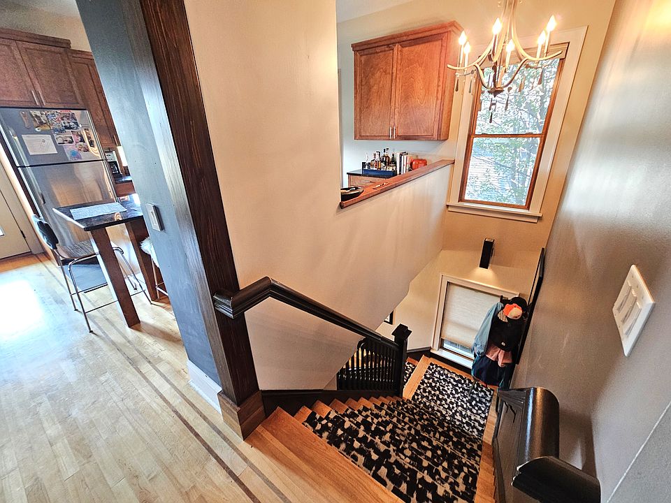 Stairwell with chandelier and carpet treads.