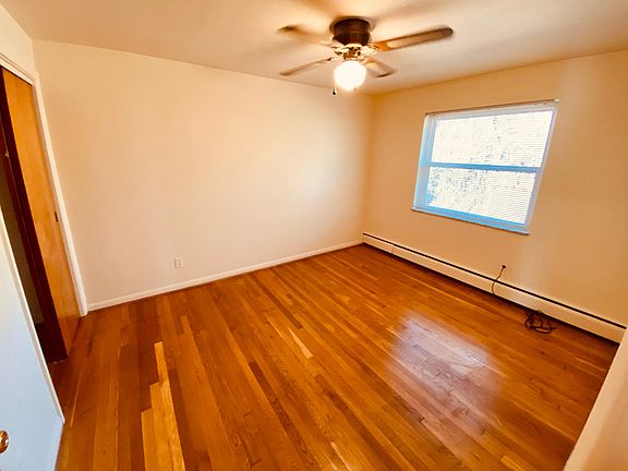 Bedroom with large window overlooking rear green space. Large closet. Ceiling fan.