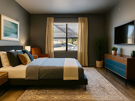 Bright bedroom with warm wood floors, soft Swiss Coffee walls, and a spacious layout. Large window brings in great natural light, with room for a king bed, storage, and seating. A calm, modern space that's easy to personalize.