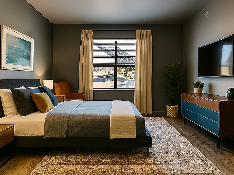 Bright bedroom with warm wood floors, soft Swiss Coffee walls, and a spacious layout. Large window brings in great natural light, with room for a king bed, storage, and seating. A calm, modern space that's easy to personalize.