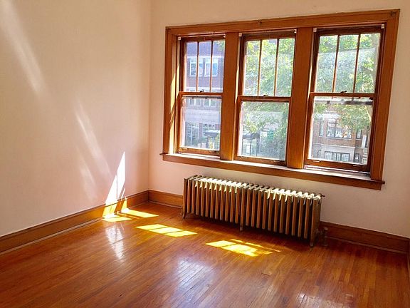 large window in the living room ,shows tree top view of streetscape and Roscoe Village's conveniences. you will absolutely love Bartoli's prize winning Pizzeria on Addison Tell them, Betty sent you !