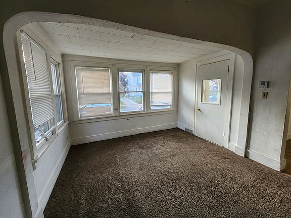 Living rm with plenty of bright windows and access to the enclosed porch
