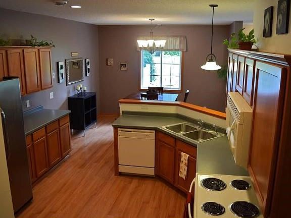 Lots of maple cabinet storage, counter space and  great breakfast bar.