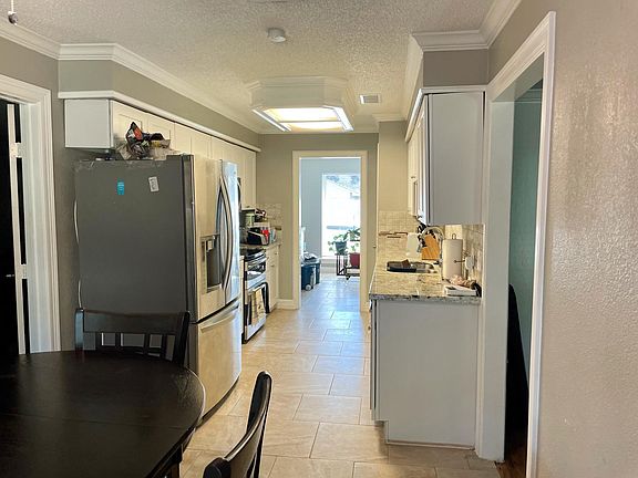 Granite counter top kitchen with adjoining eating area and connected front dining room.