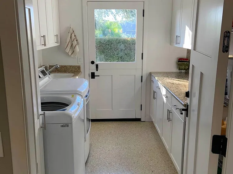 laundry room off garage with side yard door
