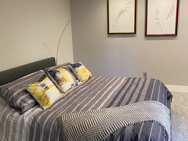 Secondary bedroom with king bed that raises and lowers. Glass slider overlooking front court yard.