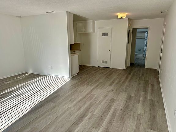 Spacious entryway to family room.

Entire unit has been completely updated with new electrical, new plumbing, new vinyl flooring and has been freshly painted throughout.