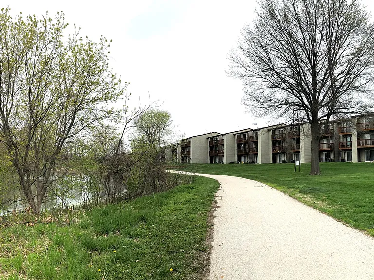 The building, pond, bicycle trail, and neighborhood