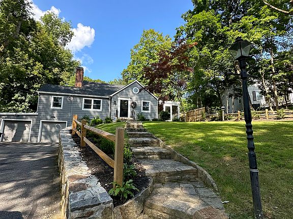 Beautiful stone masonry steps lead to grand entrance to house entrance.