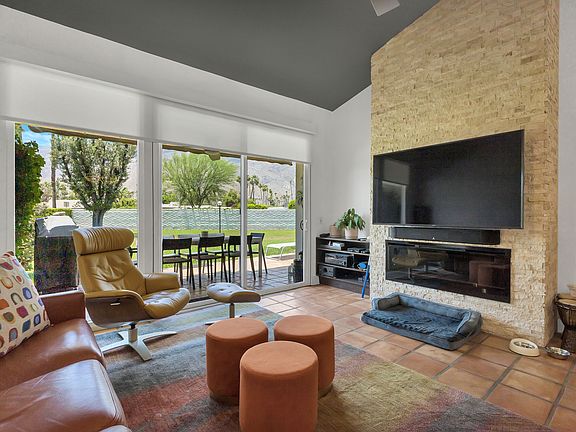 Soaring ceiling, new fan, dramatic fireplace and great TV. View to greenbelt and mountains.