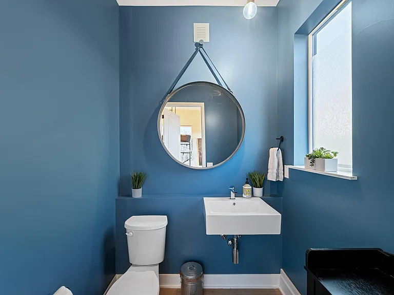 This half bathroom is on the entry level of the house for quick, convenience access. Serene blue color and pops of green plants make it a pleasant place to do your business. We also keep lotion stocked in this bathroom as we know Colorado can be dry!