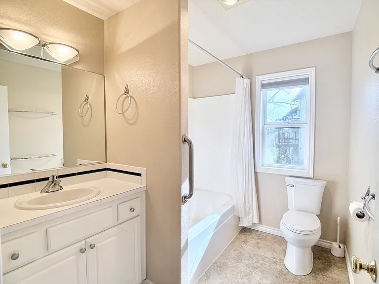 Full bathroom in the private wing offers convenient access to adjacent rooms.
