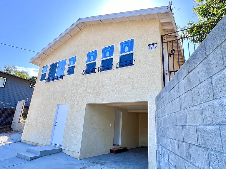 front of home with garage parking and storage room