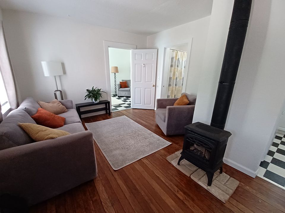 Shows gas stove heater and living room