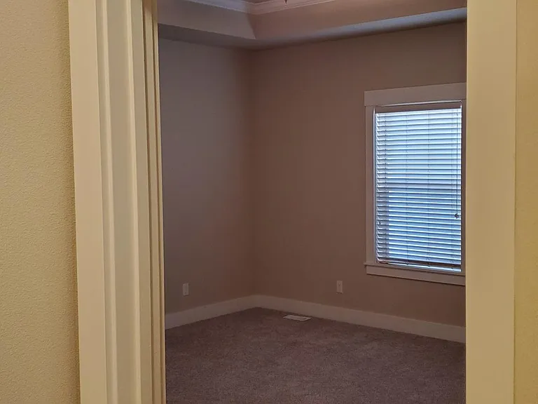 Master Bedroom with tray ceiling and ceiling fan