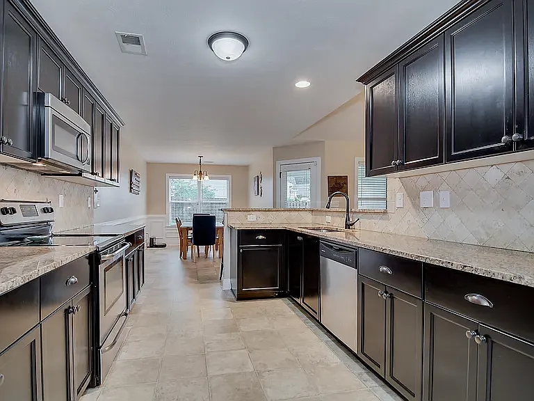 Reverse view of the kitchen into the dining room.