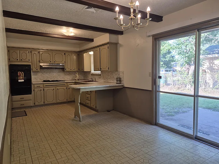 Kitchen/dining area with bar and sliding patio doors