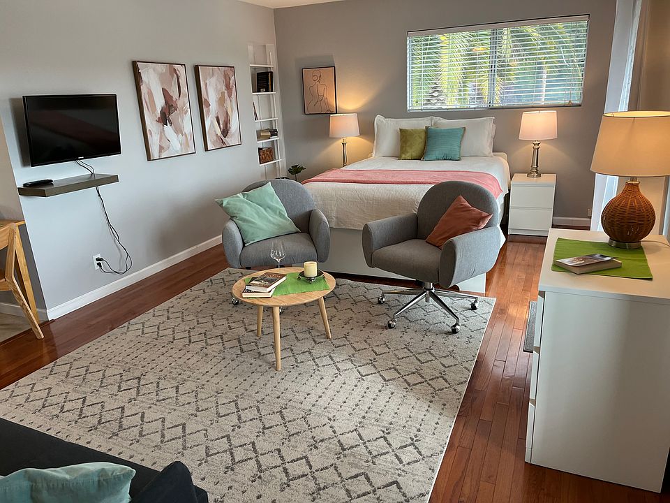 Queen size bed with swivel smart TV.