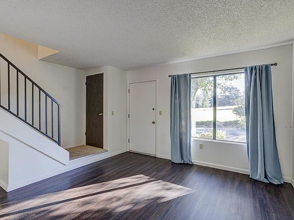 living room looking out front and to bedrooms upstairs