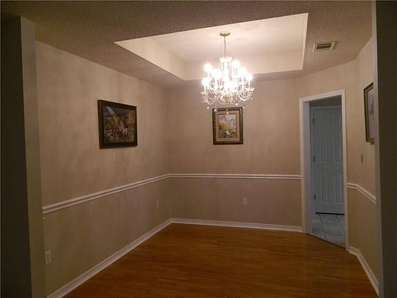 Wonderful formal dining room with a trey ceiling, molding and opening to the kitchen.