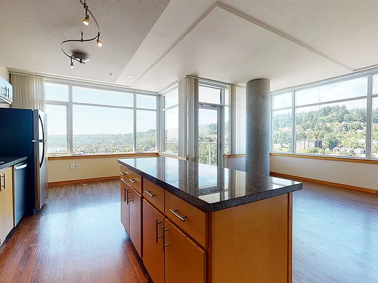 Apartment dining and living room with wood-style flooring.