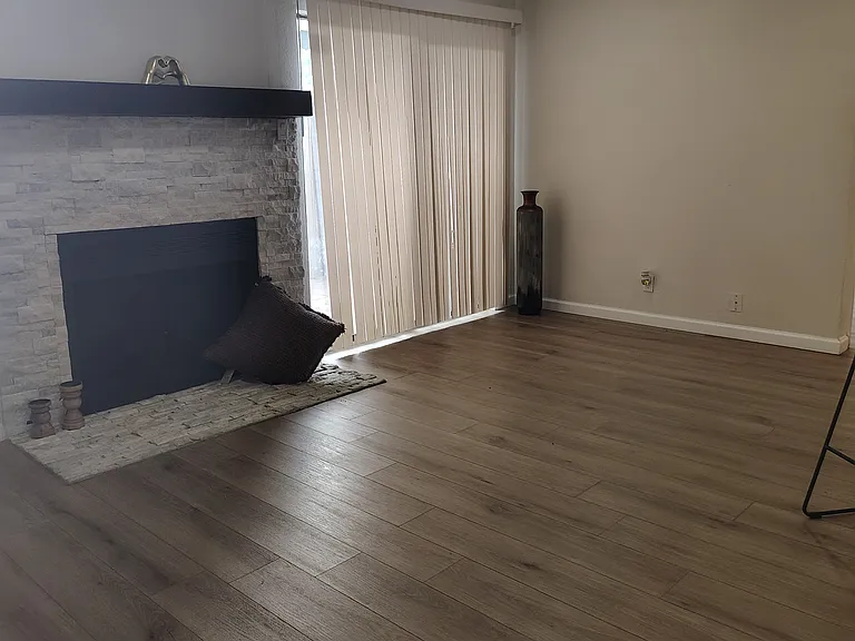 Spacious living room with New vinyl floors,light fixtures and Natural stone Fireplace!