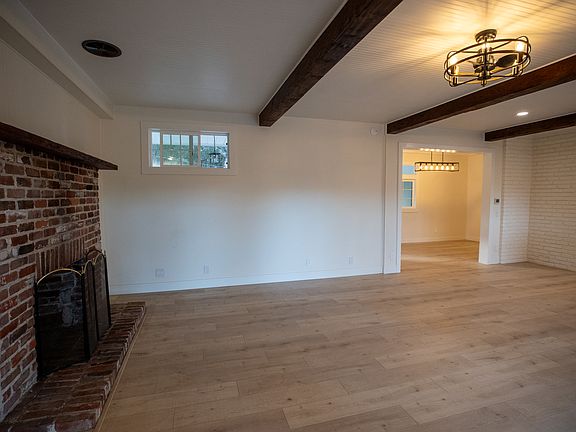 High ceilings with exposed beams and brand new flooring.
