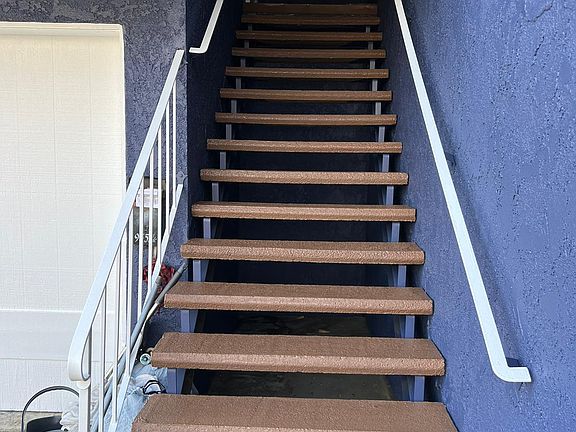 Entrance to Unit with ski light, and light fixture. Screen iron door for double protection or to open entry door and allow airflow.