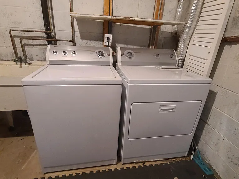 LG internet capable washer. Kenmore Dryer. Full sized deep utility sink. Not in view - cabinets and shelving on opposite side wall. Large additional space for storage.
