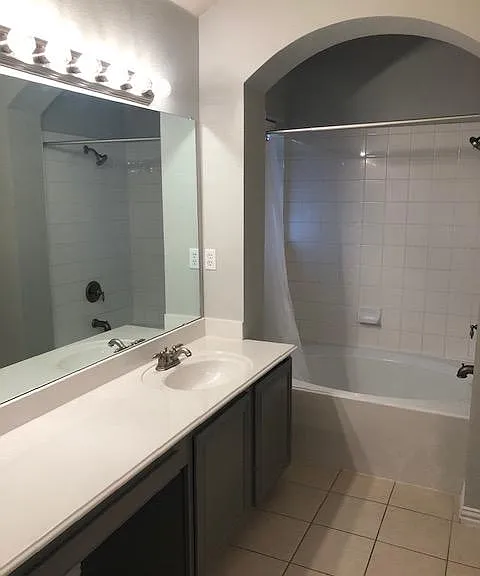 His and her large bathroom counter tops are well lit and offer plenty of storage space.