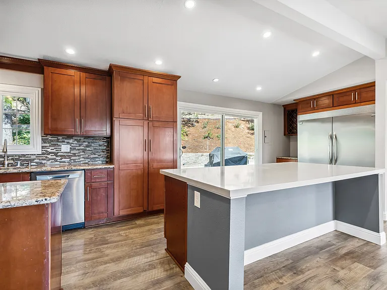 Kitchen and counter. Lots of cabinets, storage, and big food pantry