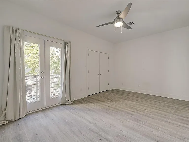 The 2nd secondary bedroom - has its own balcony that overlooks backyard space.