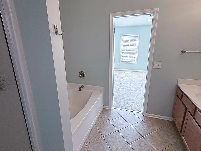 Main Bathroom with soaking tub and Delta fixtures.