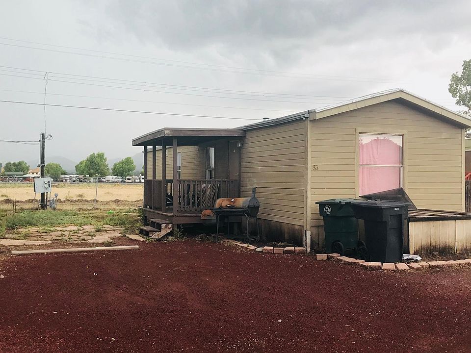 Front of house view with driveway and yard pictured. Back ha