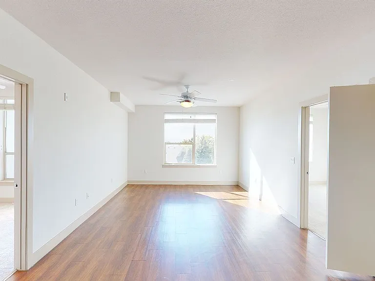 Apartment dining and living room with wood-style flooring.