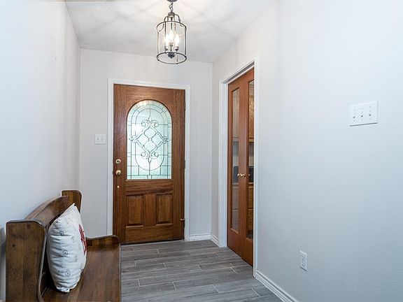 Welcome into the entry with leaded glass front door.
