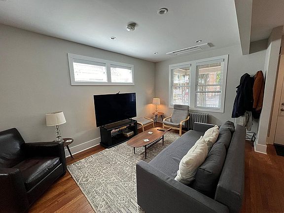 Living room with ceiling cassette type air conditioning.
