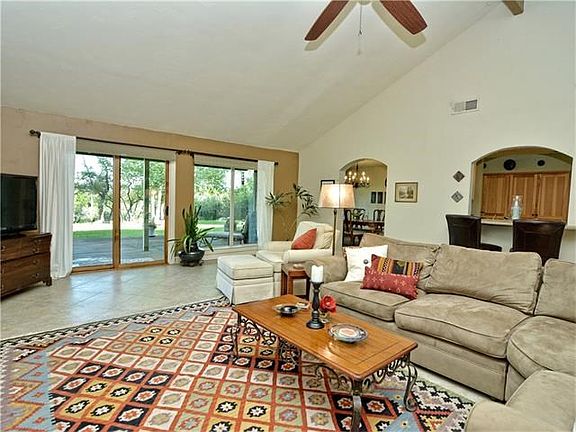 Large Living Room with two large doors that provide beautiful hill country views.